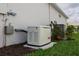 Exterior view of a Generac generator, providing reliable backup power for the home during outages at 9978 Bright Water Drive, Englewood, FL 34223