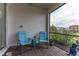 Screened lanai with comfortable seating, offering a relaxing outdoor space with views of the surrounding greenery at 9978 Bright Water Drive, Englewood, FL 34223