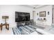 Spacious living room with tile floors, modern furniture, stylish decor, and ample natural light at 9978 Bright Water Drive, Englewood, FL 34223