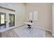 Bright office space featuring high ceilings, wood floors, white modern desk and decor at 1314 Brambling Ct, Bradenton, FL 34212