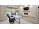 Modern office with a fireplace, television, backyard access, and neutral decor at 1314 Brambling Ct, Bradenton, FL 34212
