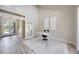 Bright office space featuring high ceilings, wood floors, white modern desk and decor at 1314 Brambling Ct, Bradenton, FL 34212