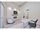 Modern office with fireplace, television, chair, and open access to other rooms at 1314 Brambling Ct, Bradenton, FL 34212