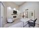 Modern office with fireplace, television, chair, and open access to other rooms at 1314 Brambling Ct, Bradenton, FL 34212