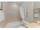 Cozy bathroom featuring neutral tiling, a shower with curtain, and well-lit vanity area at 16741 Ellsworth Ave, Bradenton, FL 34202