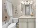 Bathroom with a bathtub and shower combination, neutral tiling, and a bright vanity area at 16741 Ellsworth Ave, Bradenton, FL 34202