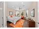 Bright bedroom with wood floors, a ceiling fan, recessed lighting, and a large window at 16741 Ellsworth Ave, Bradenton, FL 34202