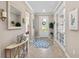 Inviting foyer with tile flooring, mirror, and a view of the front door with decorative wreath at 16741 Ellsworth Ave, Bradenton, FL 34202