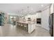 Spacious kitchen with a large center island, white cabinets, stainless steel appliances, and pendant lighting at 16741 Ellsworth Ave, Bradenton, FL 34202