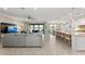 Open-concept living room and kitchen with large windows offering views of the water at 16741 Ellsworth Ave, Bradenton, FL 34202