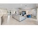 This expansive living room features stylish tile flooring, a comfortable sofa, and a modern entertainment center at 16741 Ellsworth Ave, Bradenton, FL 34202