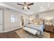 This elegant main bedroom has a tray ceiling, ceiling fan, and a decorative rug at 16741 Ellsworth Ave, Bradenton, FL 34202