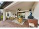 Covered outdoor patio features stylish wicker seating, lake view, and a mounted television at 16741 Ellsworth Ave, Bradenton, FL 34202