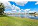 Scenic view of a pond surrounded by lush green grass and a bright blue sky at 16741 Ellsworth Ave, Bradenton, FL 34202