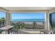 Spacious balcony with seating offering unobstructed views of the ocean and pristine sandy beach at 2675 Gulf Of Mexico Dr # 301, Longboat Key, FL 34228