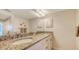 Bathroom featuring dual sinks, granite countertops, vanity lighting, and neutral walls at 2675 Gulf Of Mexico Dr # 301, Longboat Key, FL 34228