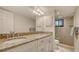 Elegant bathroom with double sinks, granite countertops, and a modern glass-enclosed shower at 2675 Gulf Of Mexico Dr # 301, Longboat Key, FL 34228
