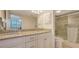 Bathroom featuring granite countertops, double sinks, glass shower door, and white cabinets at 2675 Gulf Of Mexico Dr # 301, Longboat Key, FL 34228
