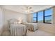 Bright bedroom features twin beds, a large window offering a great view and soft neutral tones at 2675 Gulf Of Mexico Dr # 301, Longboat Key, FL 34228