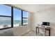 Bright bedroom features a work area with a beach view by the window and beach access at 2675 Gulf Of Mexico Dr # 301, Longboat Key, FL 34228