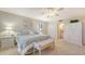 Relaxing bedroom featuring a king-sized bed, stylish bench, and convenient ensuite bathroom access at 2675 Gulf Of Mexico Dr # 301, Longboat Key, FL 34228