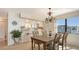 Charming dining area with a chandelier, wooden table, and views of the kitchen at 2675 Gulf Of Mexico Dr # 301, Longboat Key, FL 34228