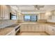 Modern kitchen with granite counters, stainless steel appliances and mosaic backsplash at 2675 Gulf Of Mexico Dr # 301, Longboat Key, FL 34228