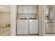 Organized laundry area equipped with new washer/dryer units and stainless steel refrigerator at 2675 Gulf Of Mexico Dr # 301, Longboat Key, FL 34228