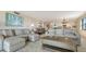 Spacious living room featuring plush sofas, a wooden coffee table, and neutral decor at 2675 Gulf Of Mexico Dr # 301, Longboat Key, FL 34228