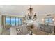 Bright living room featuring stylish chandelier, furnishings, and ocean views at 2675 Gulf Of Mexico Dr # 301, Longboat Key, FL 34228