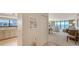 Open living space with water views, kitchen access, and neutral tones at 2675 Gulf Of Mexico Dr # 301, Longboat Key, FL 34228