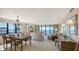 Open living space with ocean views, chandelier, and neutral tones create a relaxed atmosphere at 2675 Gulf Of Mexico Dr # 301, Longboat Key, FL 34228