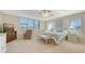Spacious main bedroom features large windows, ceiling fan, sitting area, and carpet floors at 2675 Gulf Of Mexico Dr # 301, Longboat Key, FL 34228
