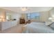 Comfortable main bedroom features ample dresser storage, carpet floors, and a seating area at 2675 Gulf Of Mexico Dr # 301, Longboat Key, FL 34228