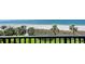 Balcony view with palm trees, beach access, and ocean views for an exciting and relaxing experience in paradise at 2675 Gulf Of Mexico Dr # 301, Longboat Key, FL 34228