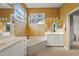 Bathroom with a large soaking tub, dual sinks, and a separate shower for ultimate relaxation at 28 Tall Trees Ct, Sarasota, FL 34232
