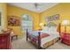 Cozy bedroom with a large window, quilt bedspread, and hardwood furniture at 28 Tall Trees Ct, Sarasota, FL 34232