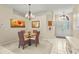 Elegant dining room featuring a chandelier, arched doorway, and a glass table with seating at 28 Tall Trees Ct, Sarasota, FL 34232