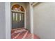 Inviting front entrance with ornate glass double doors and brick-paved porch for a welcoming arrival at 28 Tall Trees Ct, Sarasota, FL 34232