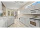 Clean kitchen with bright white cabinets, modern appliances, and breakfast nook with natural light at 28 Tall Trees Ct, Sarasota, FL 34232