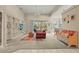 Spacious living room with neutral tones, built-in shelving, and a sliding door to a private outdoor space at 28 Tall Trees Ct, Sarasota, FL 34232