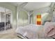 Bedroom with sliding glass doors to balcony, a walk-in closet, and a unique canopy bed at 28 Tall Trees Ct, Sarasota, FL 34232