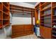 Organized walk-in closet featuring ample shelving, hanging space, and a built-in dresser at 28 Tall Trees Ct, Sarasota, FL 34232