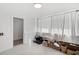 Bright bedroom featuring white walls and white curtains over the window, filled with boxes and luggage at 2930 Prospect St, Sarasota, FL 34239