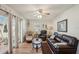 Cozy living room featuring a leather sofa, a ceiling fan and access to the porch at 3000 Holly Ave # 3000, Englewood, FL 34224