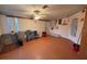 Cozy living room featuring wood floors, bright windows, and a charming ceiling fan at 3054 Mancini Ter, Punta Gorda, FL 33983