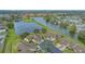 Aerial view of waterfront townhome community with mature landscaping and tranquil lake at 3119 Glen Elyn Blvd # 9, Sarasota, FL 34237