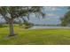 Picturesque view of a tranquil lake surrounded by manicured green lawn at 3119 Glen Elyn Blvd # 9, Sarasota, FL 34237