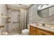 Bathroom featuring tiled shower with seat, vanity sink and tiled walls at 3119 Glen Elyn Blvd # 9, Sarasota, FL 34237
