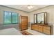 Comfortable bedroom features wood furnishings, neutral tile flooring and patterned wall decor at 3119 Glen Elyn Blvd # 9, Sarasota, FL 34237